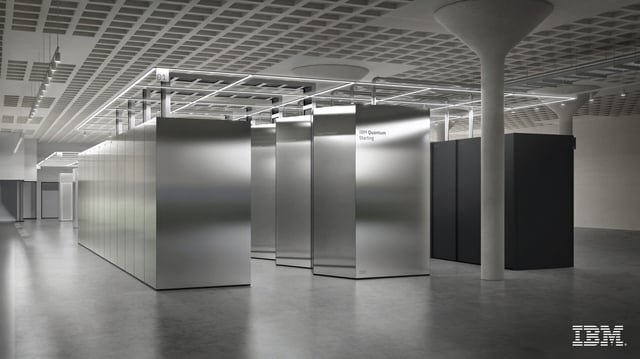 A single room filled with large silver boxes connected by metal pipes.