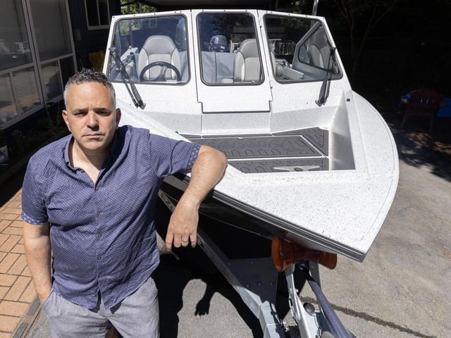 Max Mollineaux with his boat in North Vancouver.