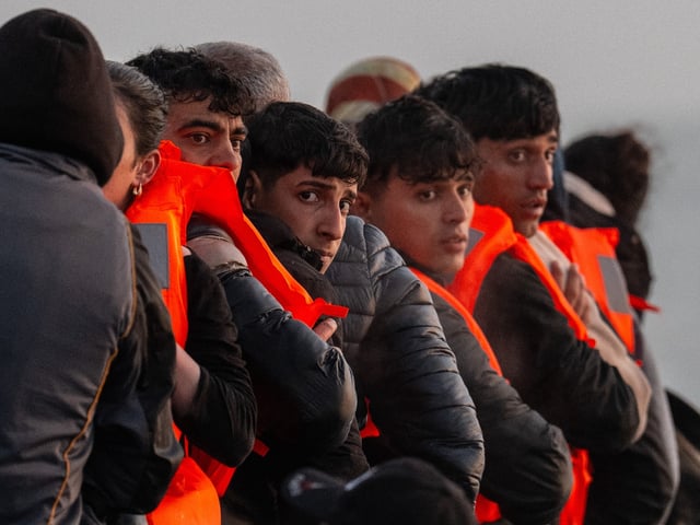 GRAVELINES, FRANCE - MAY 31: Migrants sit on a dinghy as they wait to sail into the English Channel on May 31, 2025 in Gravelines, France. The numbers of migrants crossing the English Channel in small boats is up roughly 40% on last year. It was reported in April that the UK and France are holding negotiations over a potential deal to return irregular migrants who cross the English Channel in small boats. The pilot scheme would see the UK send a limited number of people who have crossed illegally sent back to France, in exchange for accepting some people who have a case for family reunification and right to be in the UK. (Photo by Carl Court/Getty Images)
