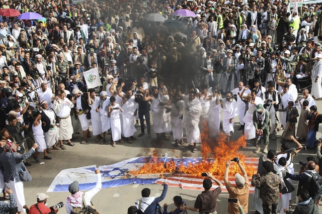 Houthi supporters wear Muslim pilgrims dress, known as &#34;Ihram&#34;, as they burn American and Israeli flags during an anti-U.S. and anti-Israel weekly rally in Sanaa, Yemen, Friday, May 30, 2025.
