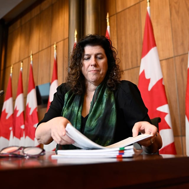 Auditor General of Canada Karen Hogan packs up her notes after participating in a news conference on four performance reports to the House of Commons, in Ottawa, on Monday, March 27, 2023. THE CANADIAN PRESS/Justin Tang