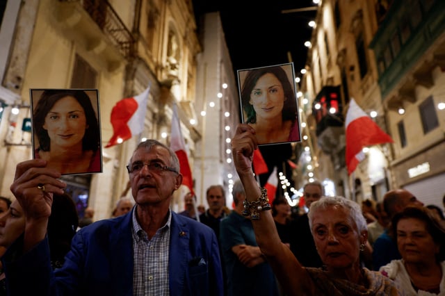 People hold up photos of late anti-corruption journalist Daphne Caruana Galizia during a protest march on the sixth anniversary of her assassination, in Valletta, Malta October 16, 2023. REUTERS/Darrin Zammit Lupi/File Photo