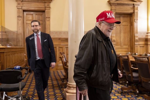 Georgia Republican elector Paul Voorhees, right, enters the Senate chambers, where electors will formally cast their votes for Donald Trump and JD Vance at the Capitol in Atlanta on Tuesday, Dec. 17, 2024.