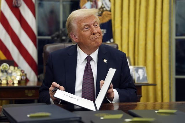 President Donald Trump signs executive orders in the Oval Office of the White House, Jan. 20, 2025, in Washington.