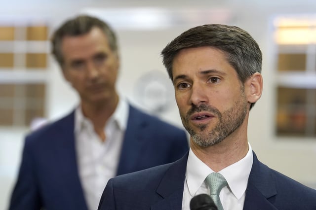 FILE - San Jose Mayor Matt Mahan, right, discusses California Gov. Gavin Newsom's, left, proposal to build 1,200 small homes across the state to reduce homelessness, during the first of a four-day tour of the state in Sacramento Calif., Thursday, March 16, 2023. (AP Photo/Rich Pedroncelli, File)