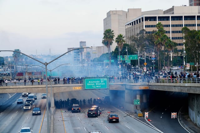 A police car burns under an overpass near Union Station in Los Angeles on June 8, 2025. Clashes between law enforcement and protesters intensified on Sunday as California National Guard troops arrived in Los Angeles to quell demonstrations against President Donald Trump's immigration crackdown, a move that the state's Democratic governor has called unlawful.