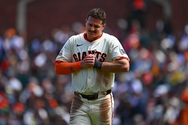 San Francisco Giants’ Matt Chapman (26) holds his right hand after injuring himself on a play in the eighth inning of their MLB game at Oracle Park in San Francisco, Calif., on Sunday, June 8, 2025. The San Francisco Giants defeated the Atlanta Braves 4-3. (Jose Carlos Fajardo/Bay Area News Group)