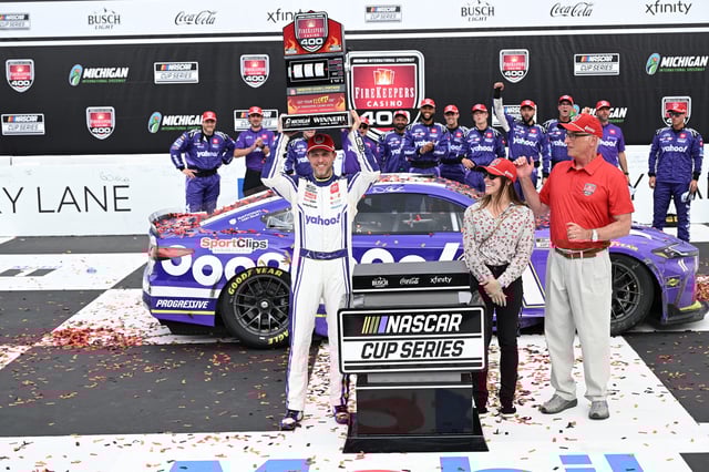 NASCAR Cup Series driver Denny Hamlin crosses the finish line to win the FireKeepers Casino 400 at Michigan International Speedway.