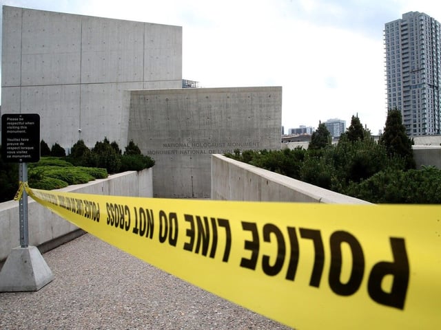 Save for a single piece of police tape, there wasn't any evidence Tuesday morning of the vandalism across one side of the National Holocaust Monument.