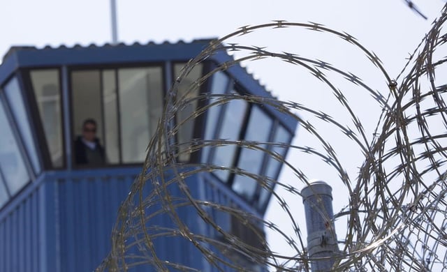 FILE - Barbed wire is seen outside a prison in the United States. U.S. authorities said a man from Los Angeles has been sentenced to 40 years behind bars for sexual exploitation and child luring.