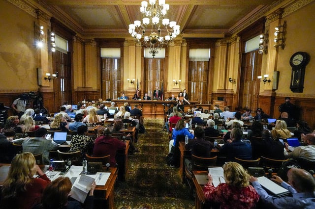 Georgia's State Election Board members discuss proposals to a full room for election rule changes at the state capitol on Sept. 20, 2024, in Atlanta.
