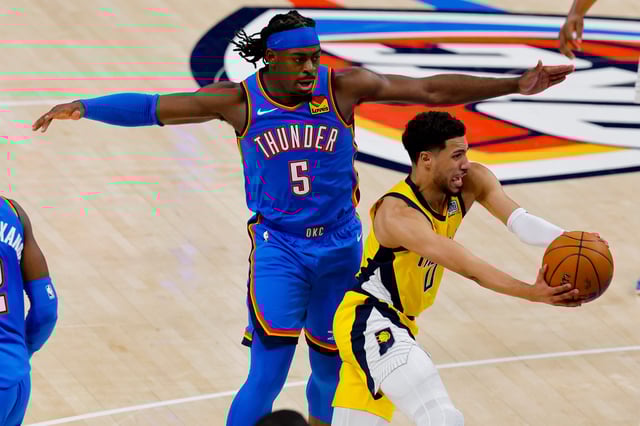 Tyrese Haliburton drives to the basket under pressure from Lu Dort during the third quarter of Game 2 of the 2025 NBA Finals.