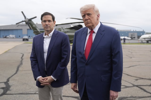 President Donald Trump, right, listens to a question from a reporter alongside Secretary of State Marco Rubio upon arriving at Morristown Municipal Airport in Morristown, N.J., en route to Camp David, Md., Sunday, June 8, 2025. (AP Photo/Manuel Balce Ceneta)
