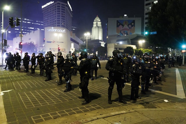  LAPD creates a perimeter to move back anti-ICE protesters on San Pedro St. on Monday, June 9, 2025 in Los Angeles, CA. (Carlin Stiehl / Los Angeles Times via Getty Images)

