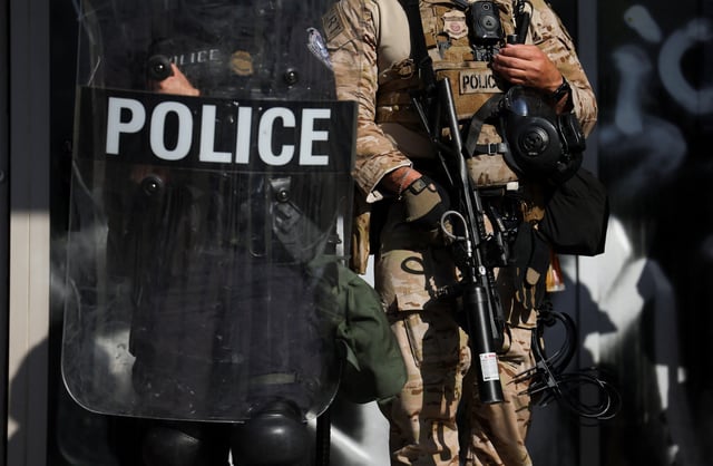 Members of law enforcement stand guard during a protest against federal immigration sweeps in downtown Los Angeles, California, U.S. June 10, 2025. REUTERS/Leah Millis