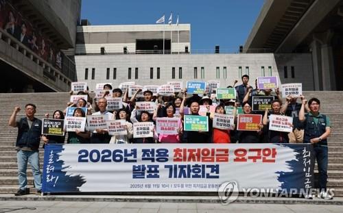 Representatives of labor and civic groups hold a news conference in Seoul on June 11, 2025, to announce their minimum wage demand for next year. (Yonhap)