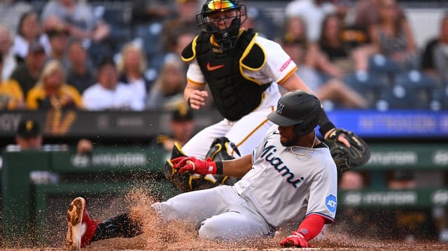 The Miami Marlins’ Otto Lopez slides home safely with a fourth-inning run under the tag from Pittsburgh Pirates catcher Henry Davis at PNC Park on Tuesday, June 10, 2025, in Pittsburgh. (Joe Sargent/Getty Images/TNS)