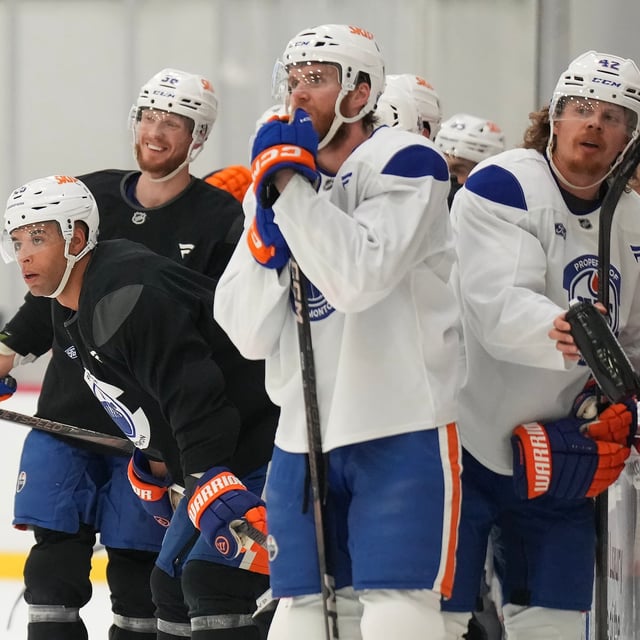 Edmonton Oilers defenceman Darnell Nurse, left, looks up ice during practice at the NHL Stanley Cup final in Fort Lauderdale, Fla., on Tuesday, June 10, 2025. THE CANADIAN PRESS/Nathan Denette