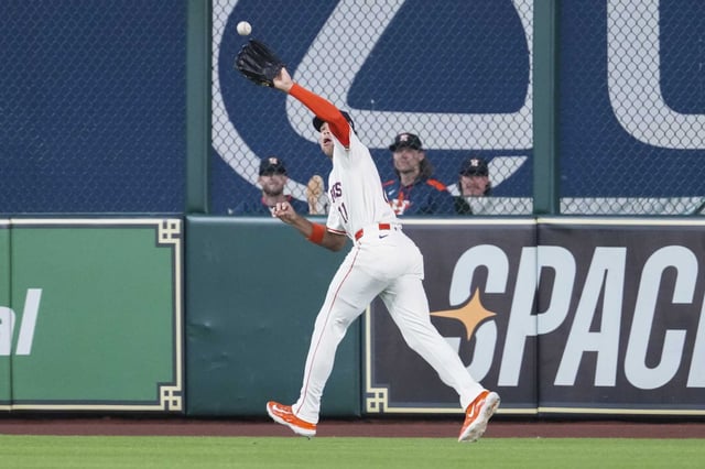 Houston Astros right fielder Cam Smith (11) fields a fly ball by Chicago White Sox Kyle Teel in the first inning of an MLB baseball game in Houston, Tuesday, June 10, 2025.
