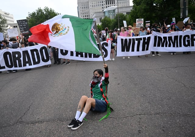 A protester named Neko, who declined to give a last name, waves a Mexican flag as she joins a large march through downtown Denver on June 10, 2025. Protesters took to the streets to demonstrate against the Trump administration&#39;s immigration enforcement action. (Photo by Helen H. Richardson/The Denver Post)