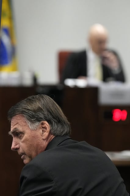 Brazil's former President Jair Bolsonaro sits before Supreme Court Judge Alexandre de Moraes during his Supreme Court trial, along with others, charged in an alleged coup plot to keep Bolsonaro in office after his 2022 election defeat, in Brasilia, Brazil, Tuesday, June 10, 2025. (AP Photo/Eraldo Peres)