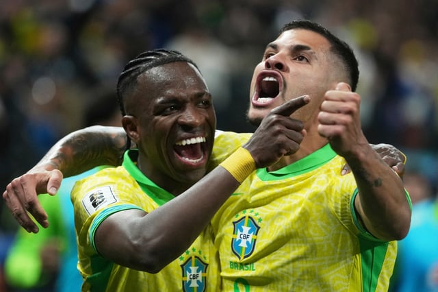 Brazil&#39;s Vinicius Junior, left, celebrates with Brazil&#39;s Bruno Guimaraes after scoring his side&#39;s opening goal against Paraguay during a World Cup 2026 qualifying soccer match at Neo Quimica Arena in Sao Paulo, Tuesday, June 10, 2025. (AP Photo/Andre Penner)