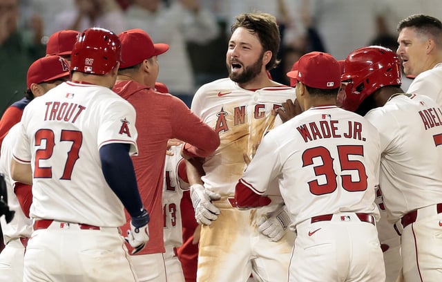 The Angels’ Nolan Schanuel, center, celebrates with teammates after his walk-off single gave them a 2-1 victory over the Athletics in the 10th inning on Tuesday night at Angel Stadium. (Photo by Ronald Martinez/Getty Images)