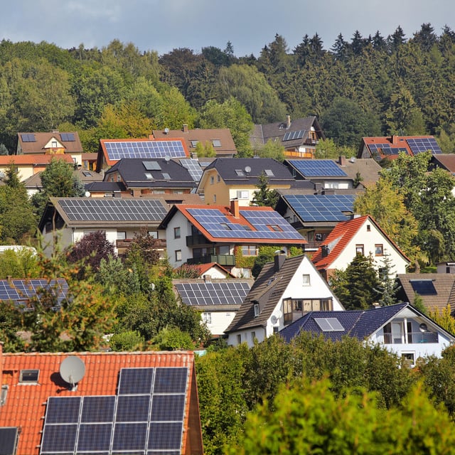 view on houses with solar thermal and photovoltaik roof systems