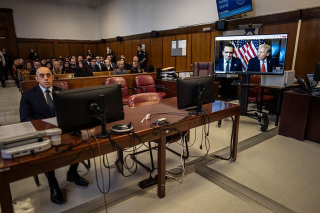 Attorney Emil Bove, left, listens as Attorney Todd Blanche and U.S. President-elect Donald Trump, seen on a television screen, appear virtually for sentencing, at Manhattan Criminal Court on January 10, 2025 in New York City.