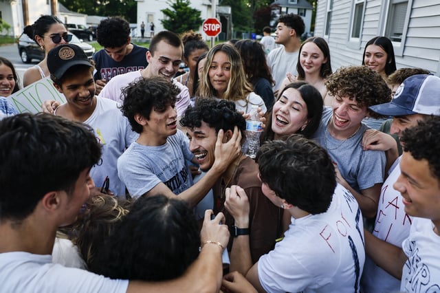 Milford, MA – June 5: Marcelo Gomes da Silva, center, is embraced by friends outside his home on June 5, 2025, after his release from ICE detention. (Photo by Erin Clark/The Boston Globe via Getty Images)
