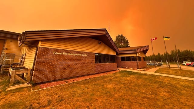 An orange-coloured haze, resulting from a nearby wildfire, is seen outside the Forest Fire Management Centre in La Ronge, Sask., in an undated handout photo. A mandatory evacuation order for the area will be lifted at 8 a.m. Thursday, officials say.