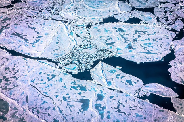 TOPSHOT - An aerial view of pancake ice and melt on July 19, 2022 as captured on a NASA Gulfstream V plane while on an airborne mission with University of Texas scientists to measure melting Arctic seaice. New observations from ICESAT-2 show remarkable Arctic Sea ice thinning in just three years. Over the past two decades, the Arctic has lost about one-third of its winter sea ice volume, largely due to a decline in sea ice that persists over several years, called multiyear ice, according to a new study. The study also found sea ice is likely thinner than previous estimates. (Photo by Kerem Yücel / AFP) (Photo by KEREM YUCEL/AFP via Getty Images)