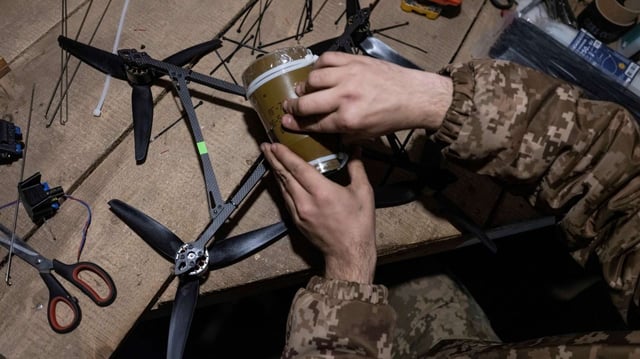 A Ukrainian soldier loads explosives onto a drone in a shelter near Kramatorsk, Ukraine, March 22, 2025 (photo by Iryna Rybakova, provided by Ukraine’s 93rd Mechanized Brigade via AP).