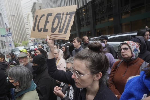 A person holds up a sign during a news conference and rally by immigrant justice organizations and advocates protesting ICE arrests in San Francisco, Wednesday, May 28, 2025.