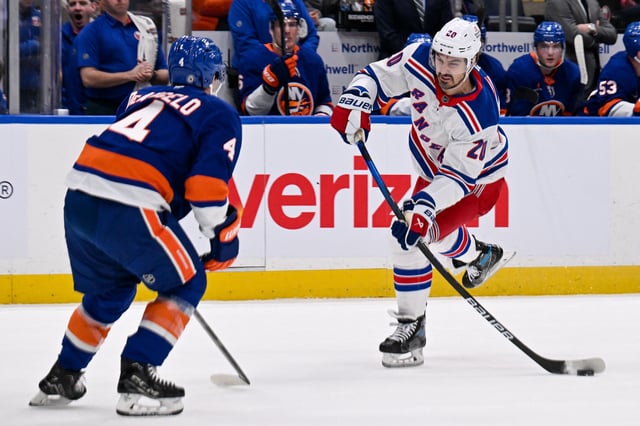 Apr 10, 2025; Elmont, New York, USA;  New York Rangers left wing Chris Kreider (20) attempts a shot defended by New York Islanders defenseman Tony DeAngelo (4) during the first period at UBS Arena. Mandatory Credit: Dennis Schneidler-Imagn Images/File Photo