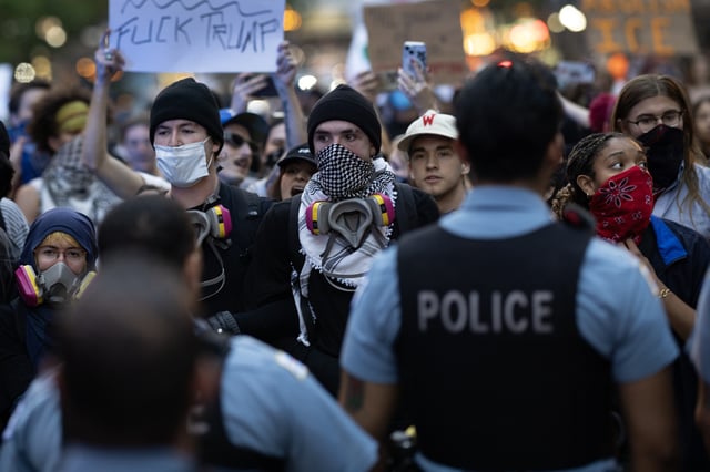 Police face off with immigrant rights protesters in the Loop on June 10, 2025 in Chicago, Illinois.