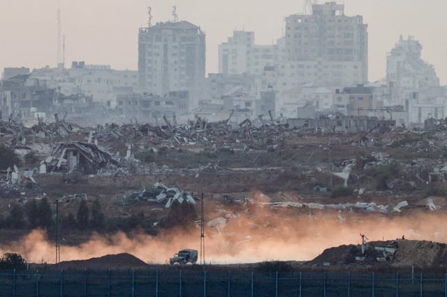 A military vehicle manoeuvres in Gaza, as seen from the Israeli side of the border, June 10, 2025. REUTERS/Amir Cohen/File photo