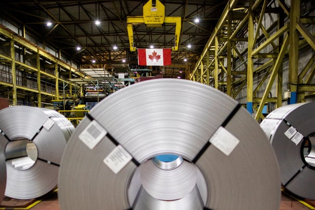 Steel coils and a flag of Canada are seen in the factory at the ArcelorMittal Dofasco steel mill in Hamilton, Ontario, Canada March 12, 2025. REUTERS/Carlos Osorio/ File Photo