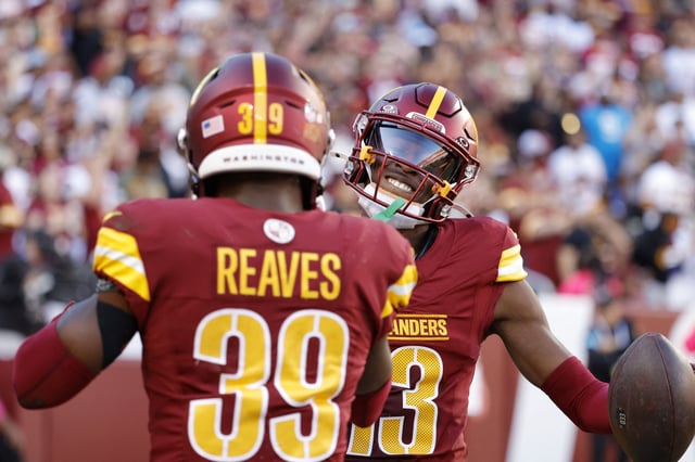 Oct 20, 2024; Landover, Maryland, USA; Washington Commanders cornerback Emmanuel Forbes Jr. (13) celebrates with Commanders safety Jeremy Reaves (39) after intercepting a pass against the Carolina Panthers during the first quarter at Northwest Stadium. Mandatory Credit: Amber Searls-Imagn Images/File Photo