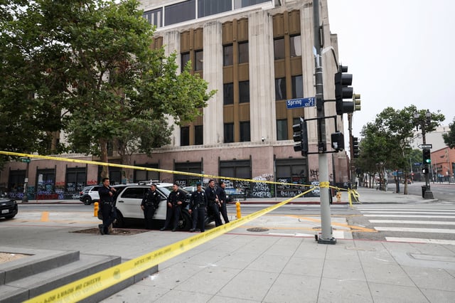 Members of law enforcement stand next to a police car, after days of protests against federal immigration sweeps and the deployment of the California National Guard and U.S. Marines, in downtown Los Angeles, California, U.S., June 11, 2025. REUTERS/Aude Guerrucci