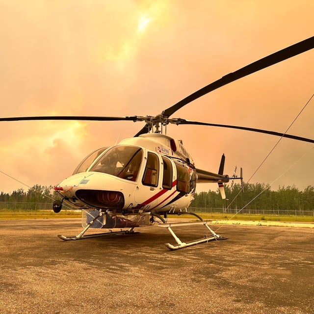 An orange-coloured haze, resulting from a nearby wildfire, is seen on a helipad in La Ronge, Sask., in an undated handout photo. THE CANADIAN PRESS/HO-Saskatchewan Public Safety Agency, *MANDATORY CREDIT*