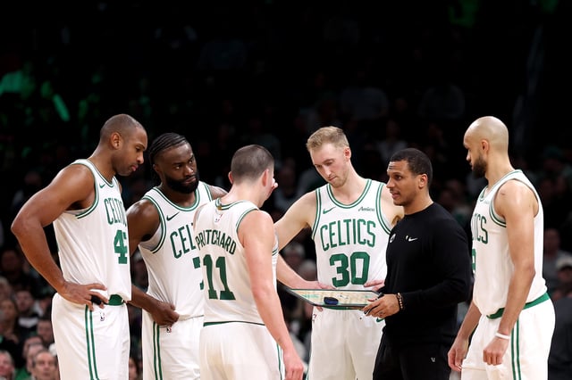 Boston Celtics head coach Joe Mazzulla stands in a huddle with Al Horford #42, Jaylen Brown #7, Payton Pritchard #11, Sam Hauser #30 and Derrick White #9 during the second half of the game against the Portland Trail Blazers at TD Garden on March 05, 2025 in Boston, Massachusetts.