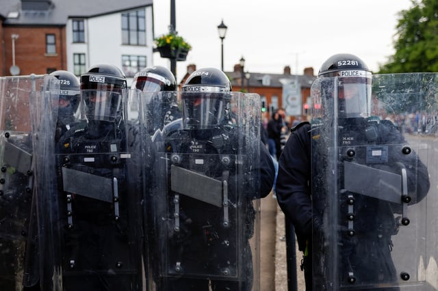 Riot police members hold their shields while they take position as riots continue in Ballymena, Northern Ireland, June 11, 2025. REUTERS/Clodagh Kilcoyne