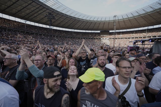 Spectators watch Bruce Springsteen and the E Street Band perform at the Olympic Stadium, in Berlin, Germany, Wednesday, June 11, 2025. (AP Photo/Markus Schreiber)