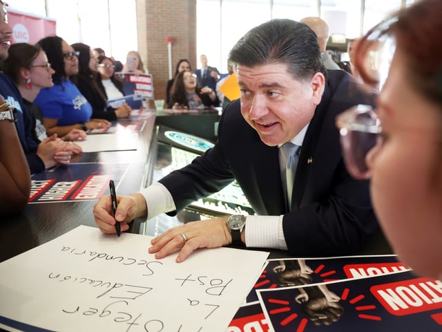 After giving a speech about higher education, Gov. JB Pritzker signs autographs at the University of Illinois Chicago on April 28, 2025. (Terrence Antonio James/Chicago Tribune)