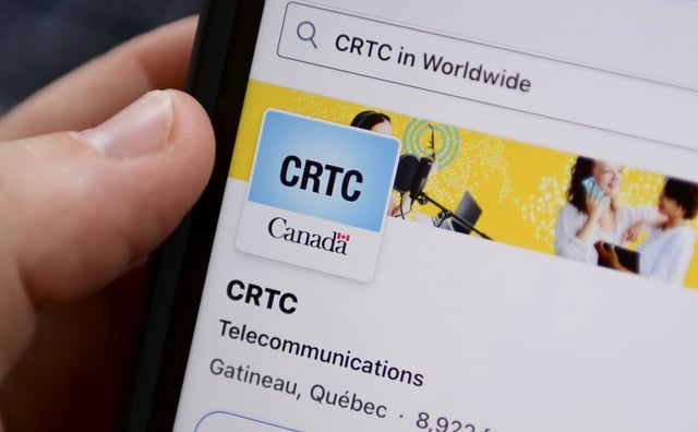 Canada's telecommunications regulator is expected to hear today from major providers and consumer advocacy groups amid its ongoing hearing about making it easier to shop for internet services. A person navigates to the online social-media pages of the Canadian Radio-television and Telecommunications Commission (CRTC) on a cellphone in Ottawa on Monday, May 17, 2021. THE CANADIAN PRESS/Sean Kilpatrick