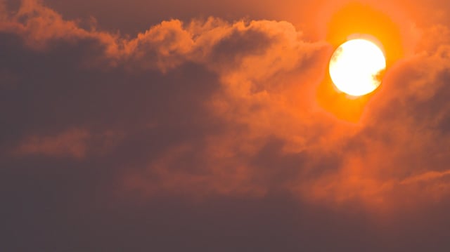 A thick orange haze hung over the city of Edmonton early Wednesday morning as the early morning sun is obscured by the thick smoke that blanketed much of Alberta.