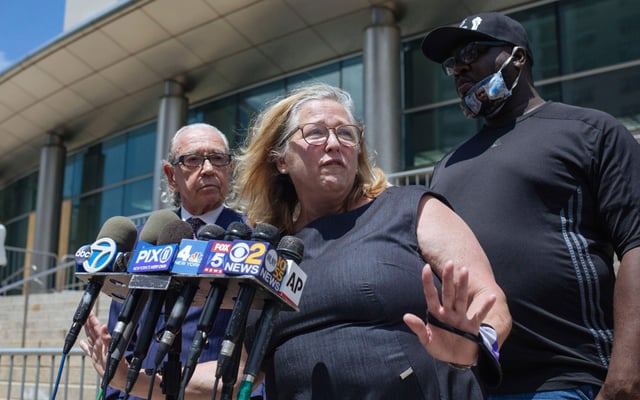 Queens Defenders Executive Director Lori Zeno, center, addresses the media outside the Queens courthouse on Thursday, June 25, 2020, in New York. (AP Photo/Kevin Hagen)