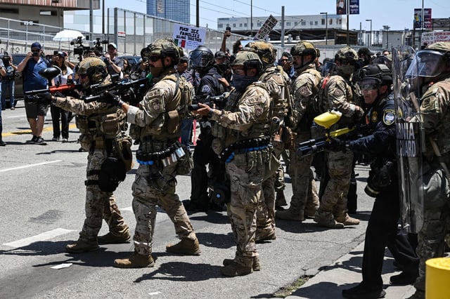 Law enforcement officers, including members of the Immigration and Customs Enforcement (ICE) Special Response Team and Homeland Security agents, are seen outside the Federal Building as protests continue in response to federal immigration operations in Los Angeles on June 10, 2025.