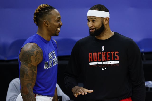 Dwight Howard #39 of the Philadelphia 76ers and DeMarcus Cousins #15 of the Houston Rockets speak before playing at Wells Fargo Center on February 17, 2021 in Philadelphia, Pennsylvania.